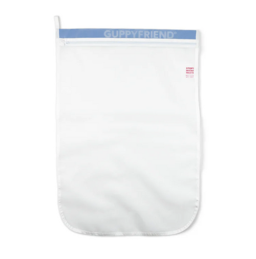 Flat lay of Guppyfriend microplastic filter bag; eco-conscious washing solution for recycled swimwear for men.