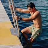 Man wearing Sage Green Blauw Short getting out of the water