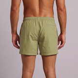 A man viewed from behind wearing quick drying Sage Green men’s swim trunks
